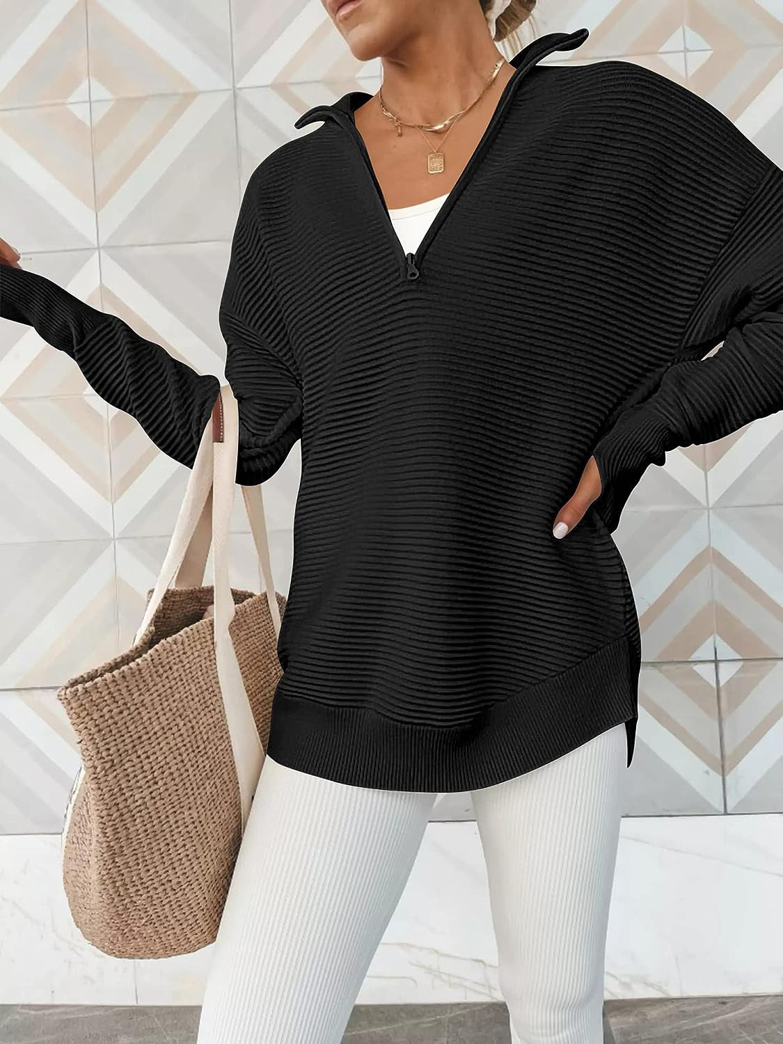 Black ribbed knit pullover with funnel neck and quarter zip, long sleeves, relaxed fit.