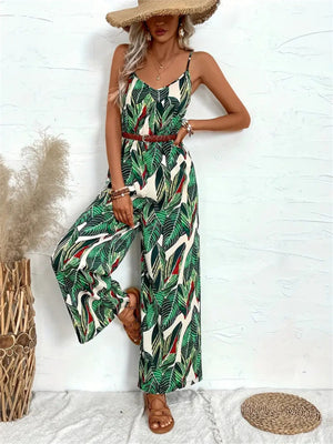 Botanical print cami jumpsuit in dark green with wide legs and a braided belt.