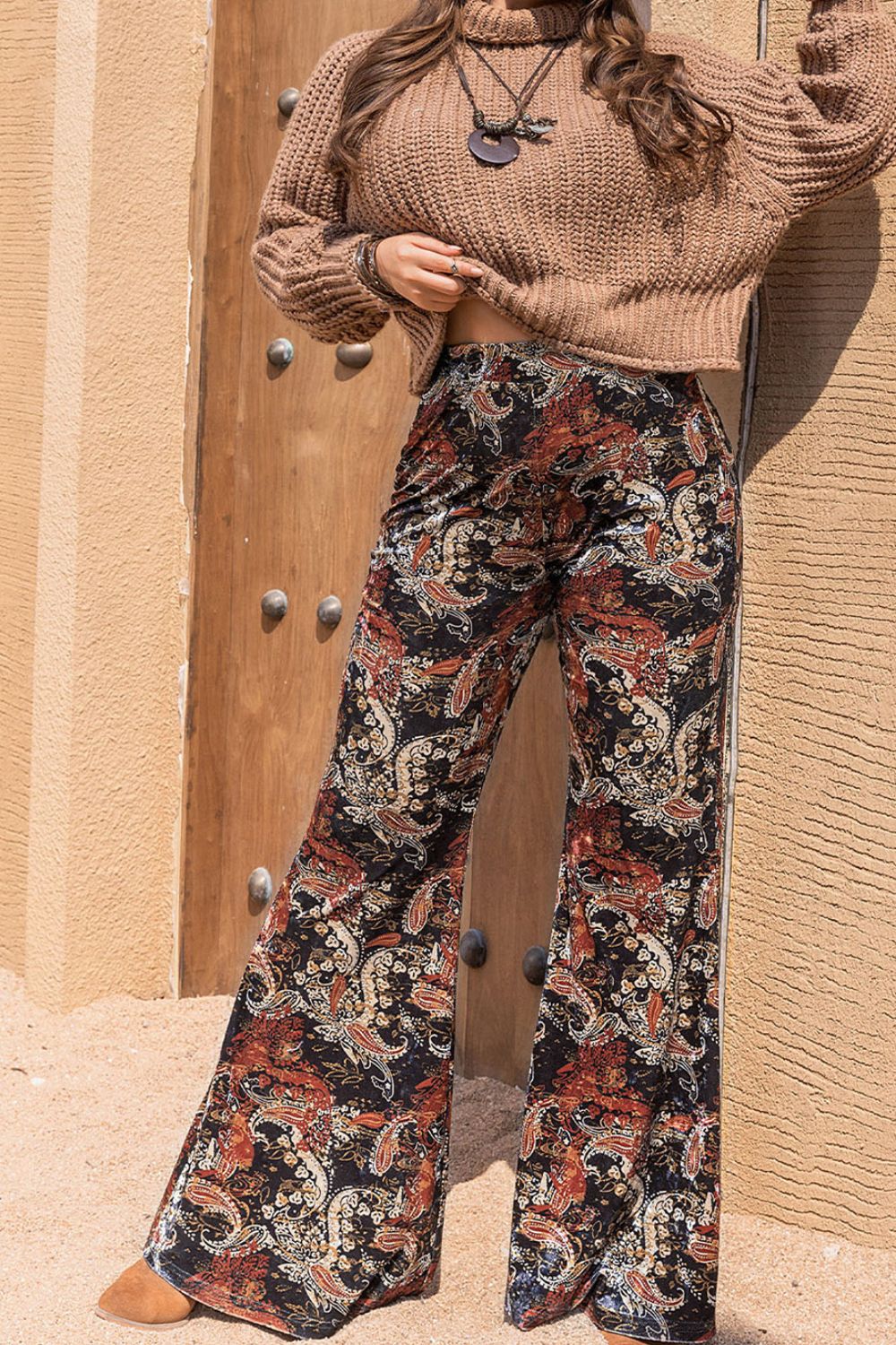 Velvet palazzo trousers in black with a paisley print and wide leg.