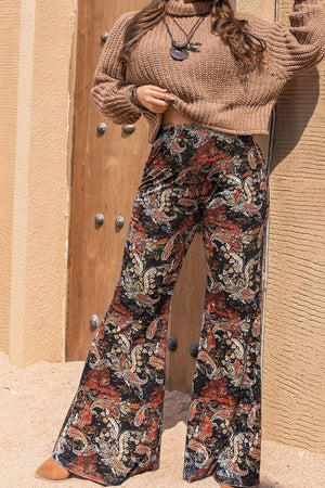 Velvet palazzo trousers in black with a paisley print and wide leg.
