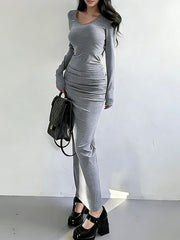 Light gray ruched long-sleeve bodycon maxi dress with a scoop neck.