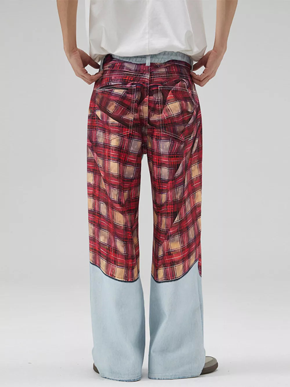 Men's wide-leg jeans with red plaid patchwork and light blue denim lower legs.
