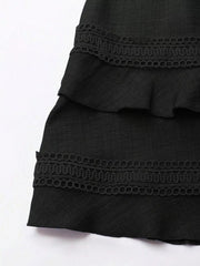 Black mini dress with tiered ruffles and lace trim detail