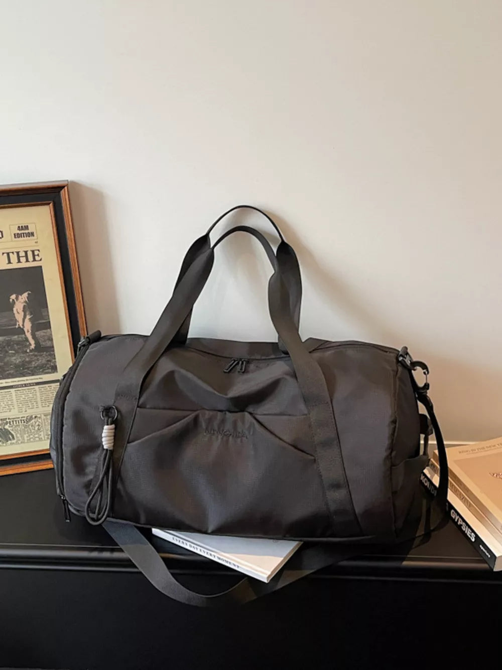Premium large black nylon travel duffle bag with multiple pockets and adjustable strap.