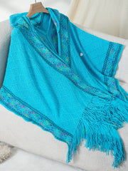 Sky blue knit hooded wrap with embroidered trim and fringe detail