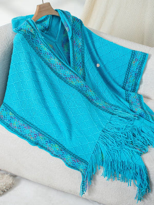 Sky blue knit hooded wrap with embroidered trim and fringe detail