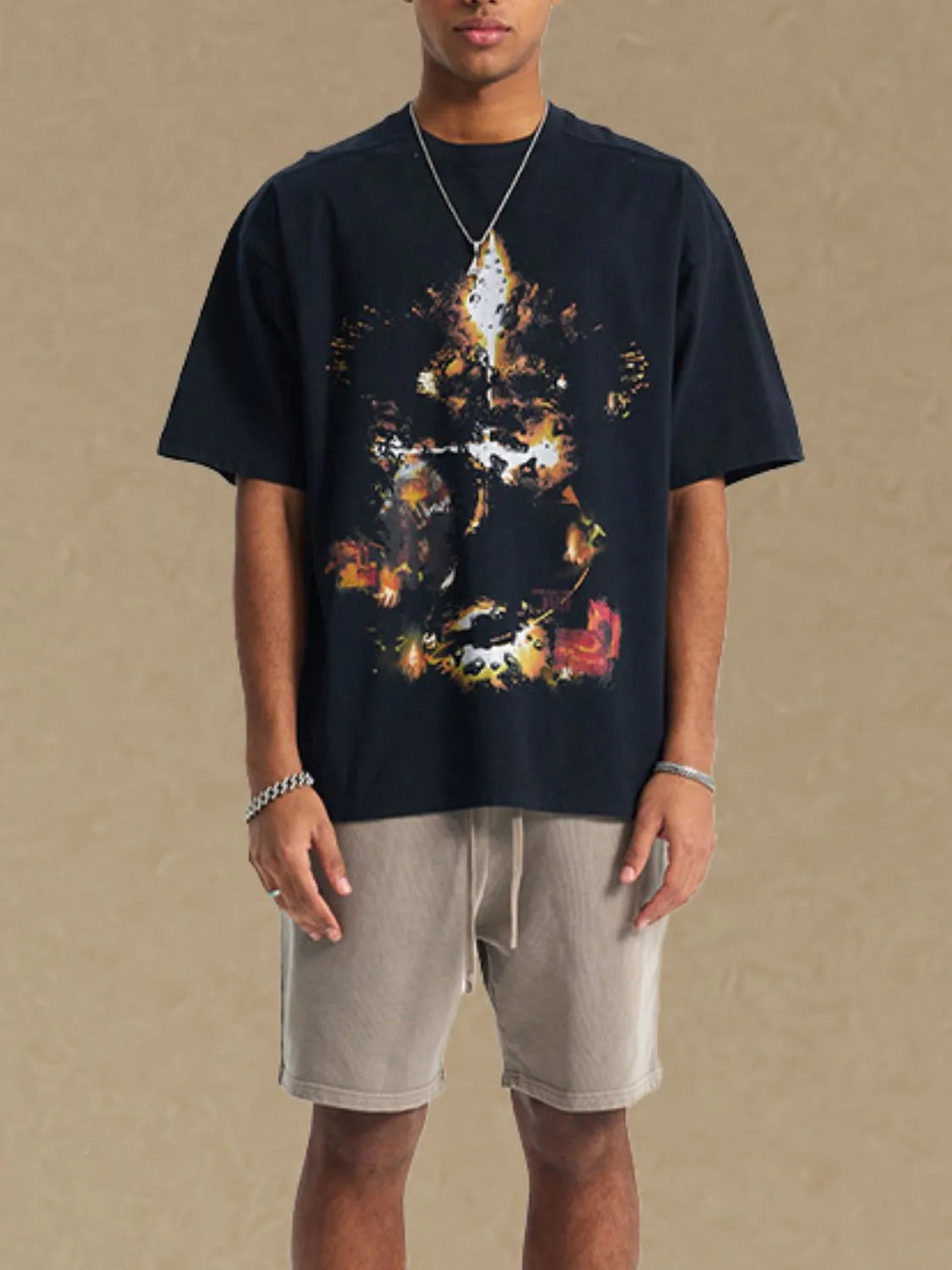 Black oversized t-shirt with abstract graphic print and crew neck.
