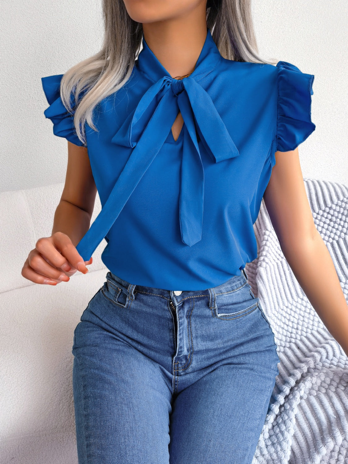 Cerulean ruffled sleeve pussybow blouse with tie detail.
