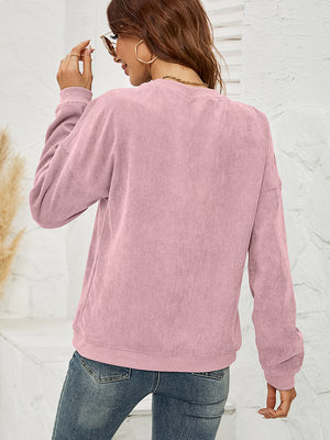 Dusty Pink corduroy crewneck sweatshirt with lip print, long sleeves, and crew neckline.