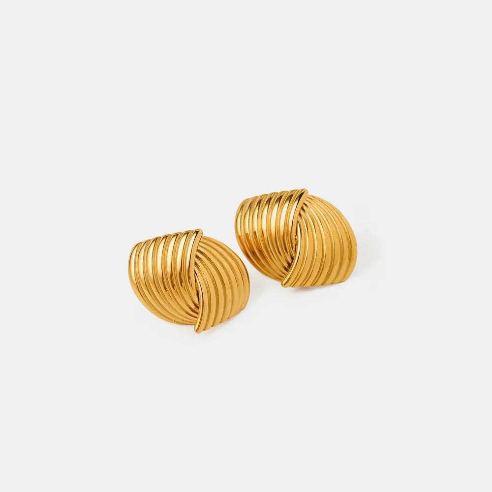 Gold coil earrings with a sculpted, ribbed design.