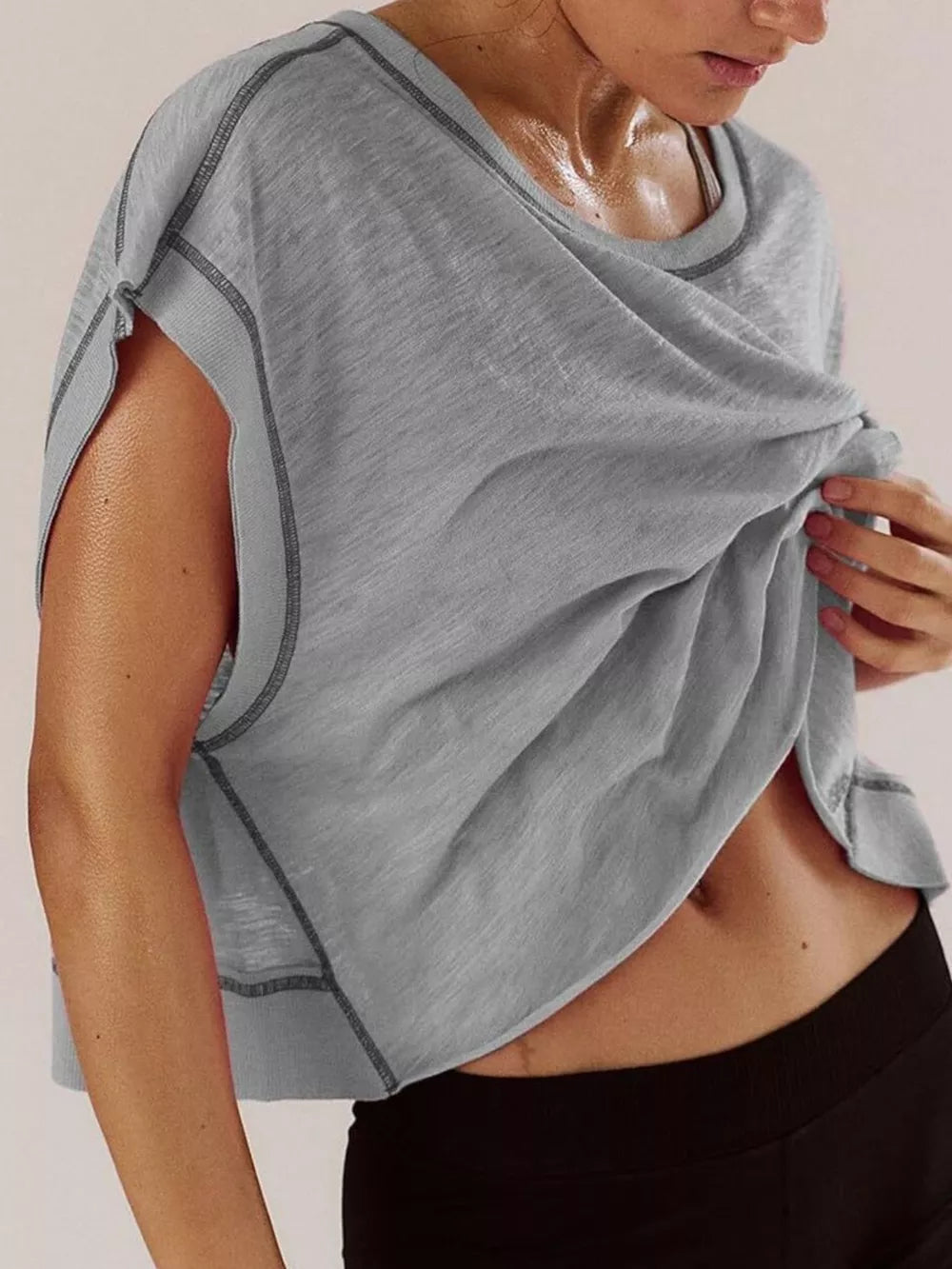 Gray t-shirt with exposed seams and a cutout back detail.