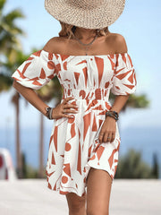 Off-shoulder mini dress with geometric print, shirred waist, and balloon sleeves in orange-red and white.
