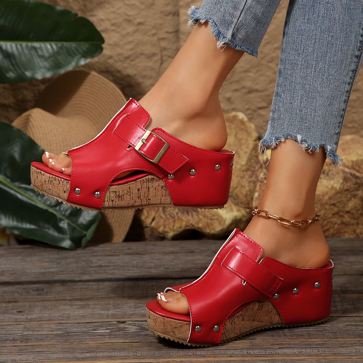 Red open-toe wedge sandals with buckle detail and cork platform.