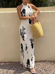 Button-down halter maxi dress in ivory with black floral print, a-line cut.
