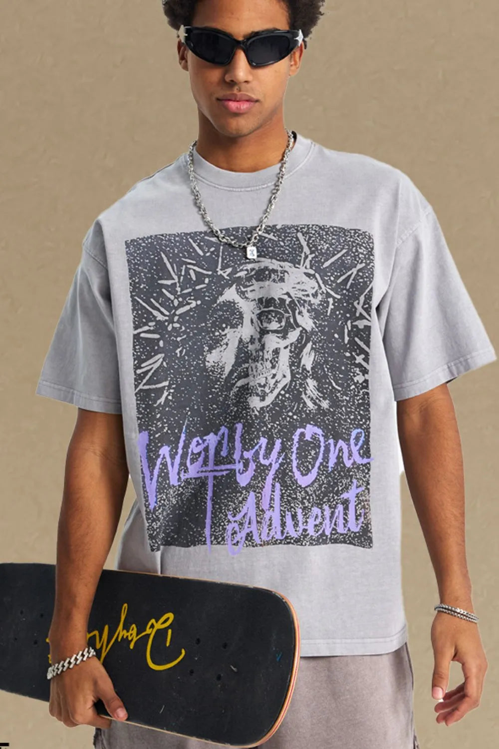 Gray oversized tee with a graphic print of a skull and text that reads "Worthy One Advent".