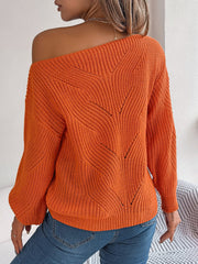 Orange off-the-shoulder knit sweater with openwork detail and relaxed fit.
