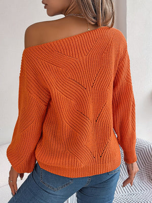 Orange off-the-shoulder knit sweater with openwork detail and relaxed fit.