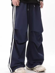Navy wide-leg sweatpants for men with white side stripes and drawstring waist.