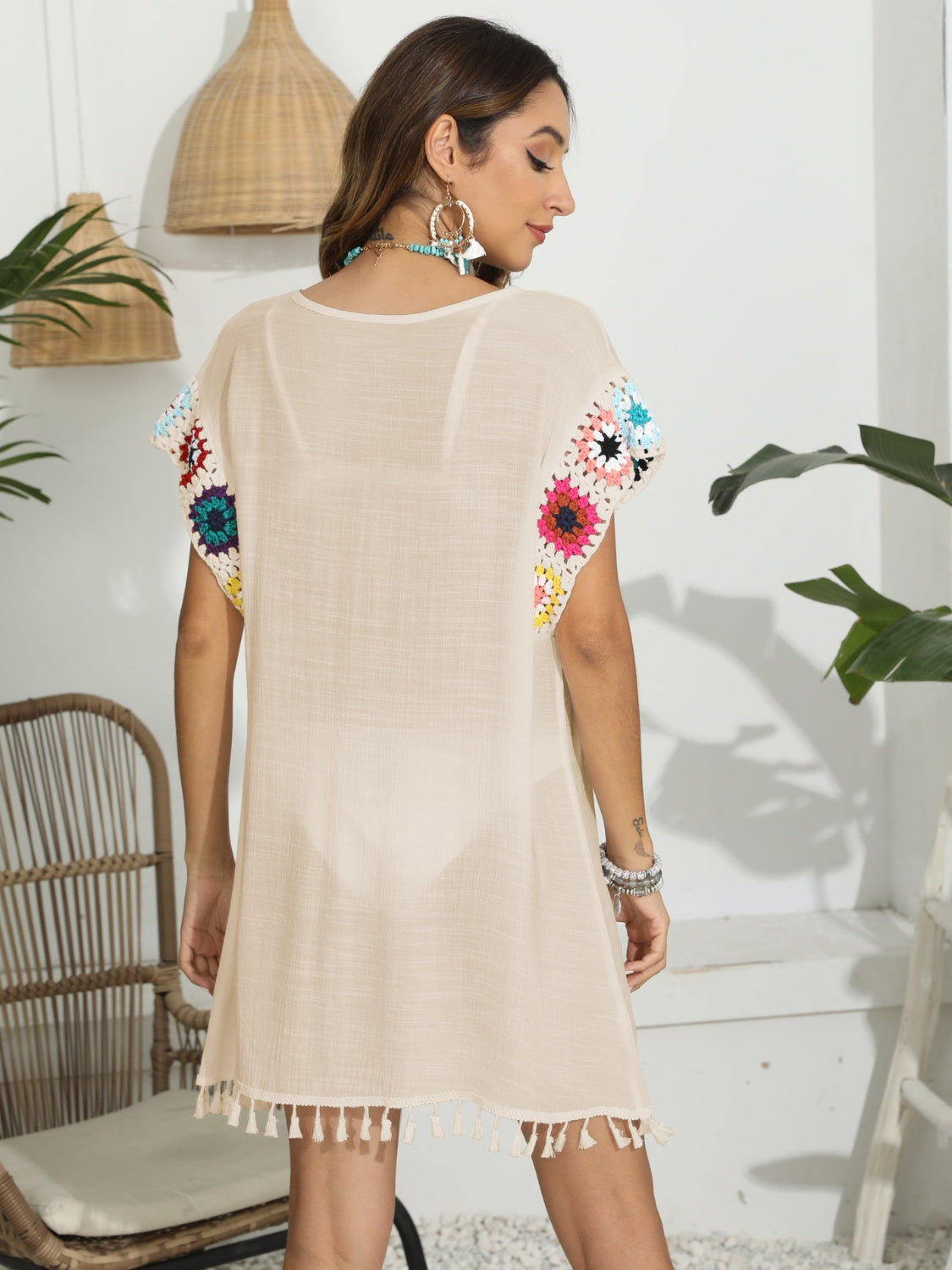 Tan tunic with crochet floral sleeves and tassel hem