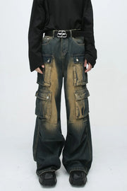 Faded wash oversized cargo jeans in dark blue denim with multiple button flap pockets and a baggy fit.