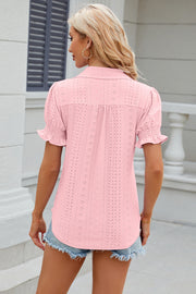 Blush pink eyelet polo blouse with short ruffled sleeves and a button-up back.