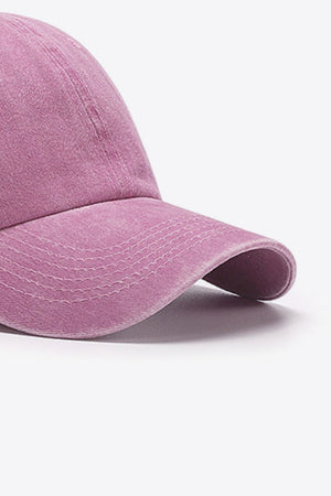 Washed cotton baseball cap in pink with stitched details on the brim.
