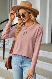 Textured blush pink henley v-neck top with button detail and long sleeves