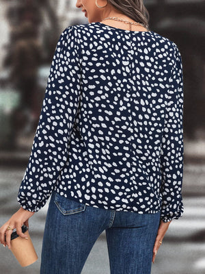 Dark blue polka dot blouse with long sleeves and tie neck detail