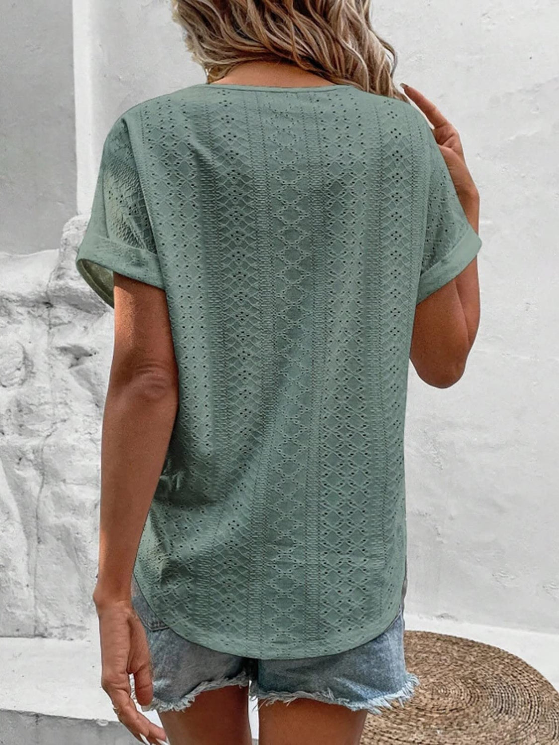 Sage eyelet v-neck tunic top with short sleeves and a relaxed fit.