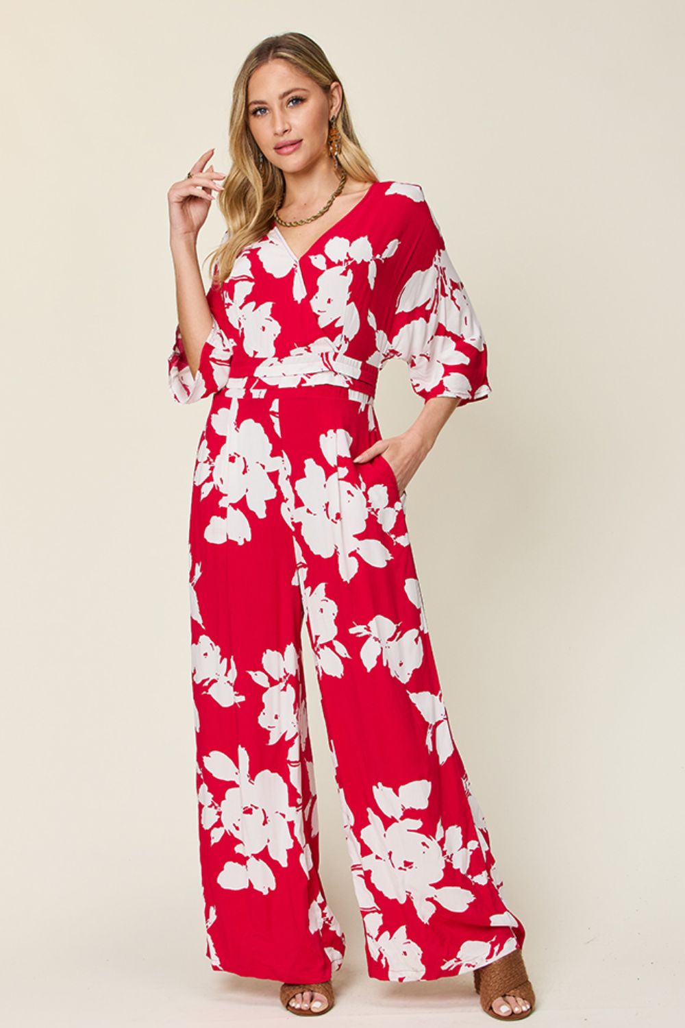 Red floral kimono jumpsuit with wide legs and a tie waist.