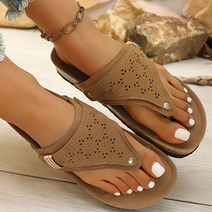 Brown hollow-out toe-post sandals with adjustable ankle strap and cork-style sole.