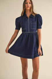Dark denim mini dress with puff sleeves, zip front, and chest pockets.