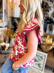 Floral print polyester blouse with lace trim on flutter sleeves.