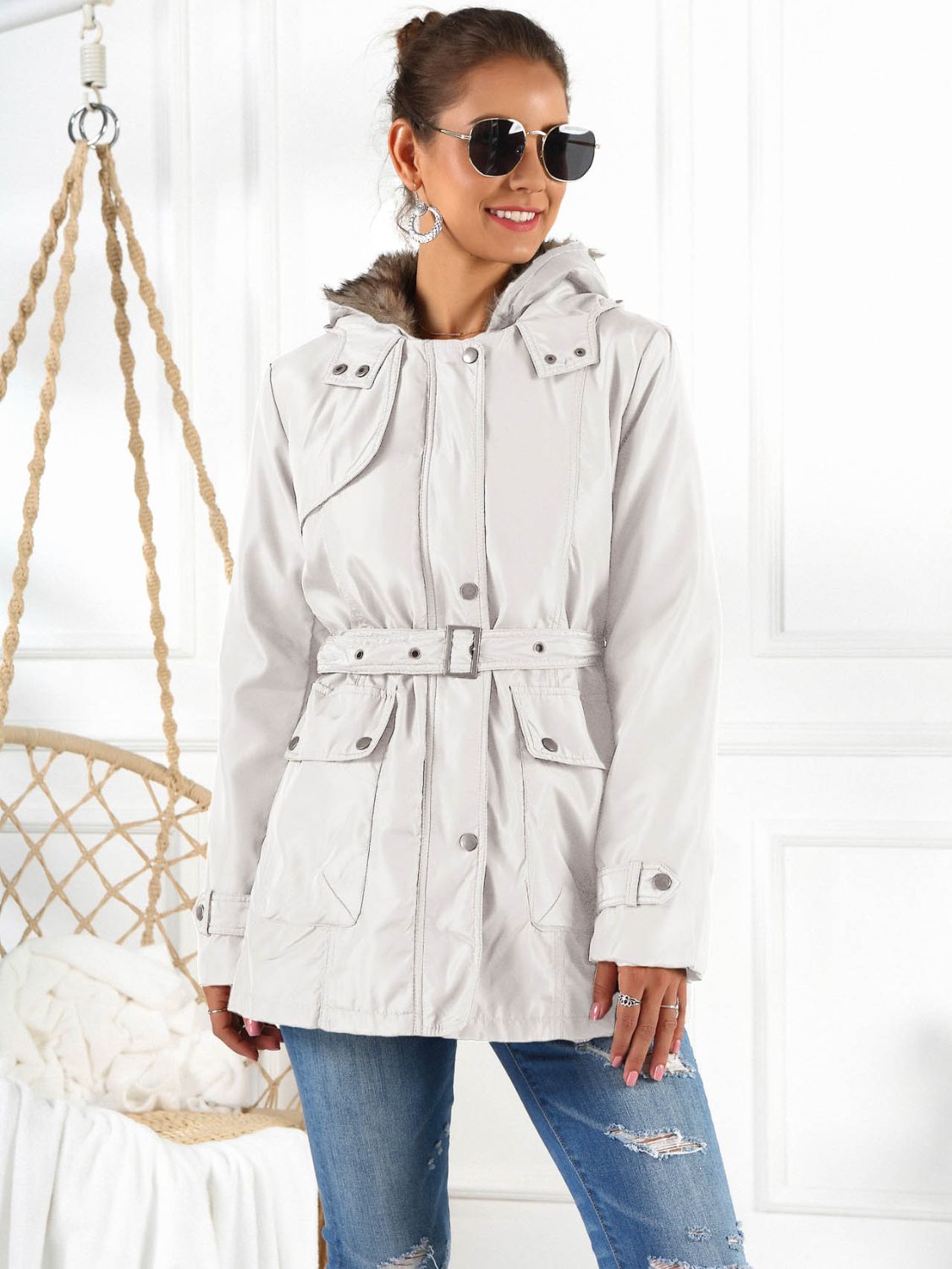 Belted utility parka in white with faux fur hood trim, snap pockets and adjustable waist belt.