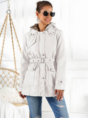 Belted utility parka in white with faux fur hood trim, snap pockets and adjustable waist belt.
