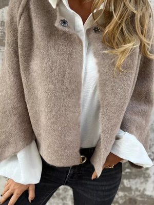 Cozy fuzzy knit cardigan in khaki with button detail, worn open over a white shirt.