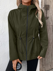 Army green utility jacket with cinched waist, hood, and zipper closure.