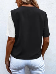 Two-tone black and white asymmetric shirt with short sleeves.