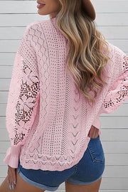 Blush pink openwork knit sweater with lace sleeves and textured knit details.