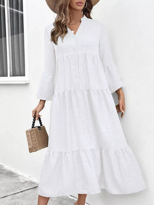 White tiered ruffle hem V-neck dress with button front and bell sleeves.