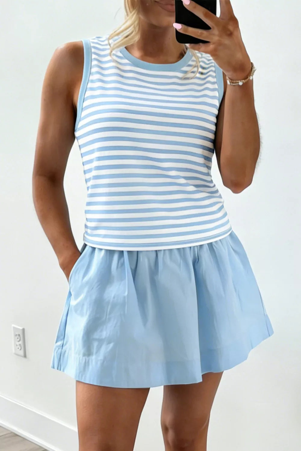 Two-piece set with blue and white striped tank top and light blue skort with pockets.