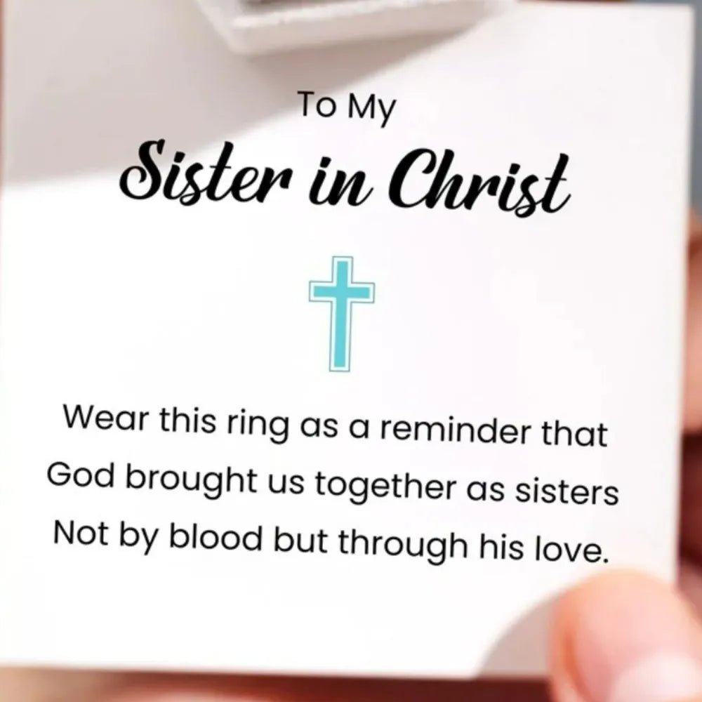 Intertwined cross sterling silver ring with blue zircon detail.