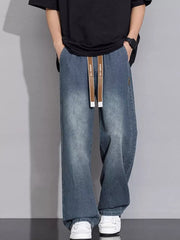 Relaxed vintage wash wide-leg jeans in gray blue with drawstring waist and cotton fabric.
