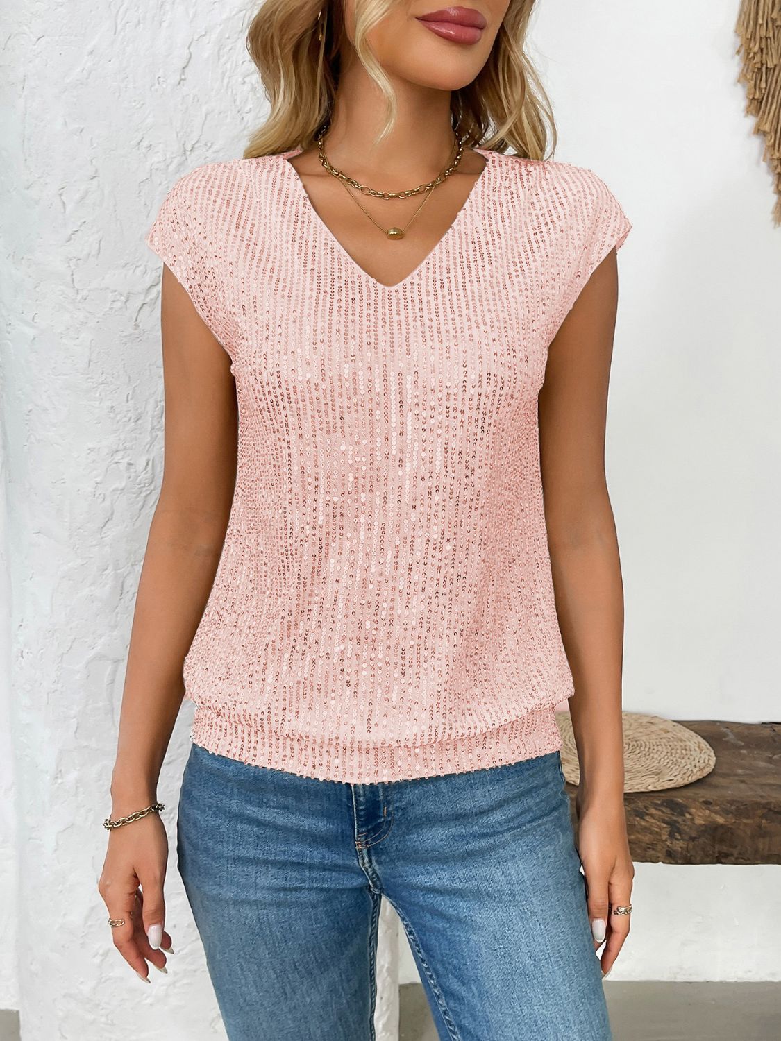 Blush pink sequined cap-sleeve V-neck blouse with cinched waist