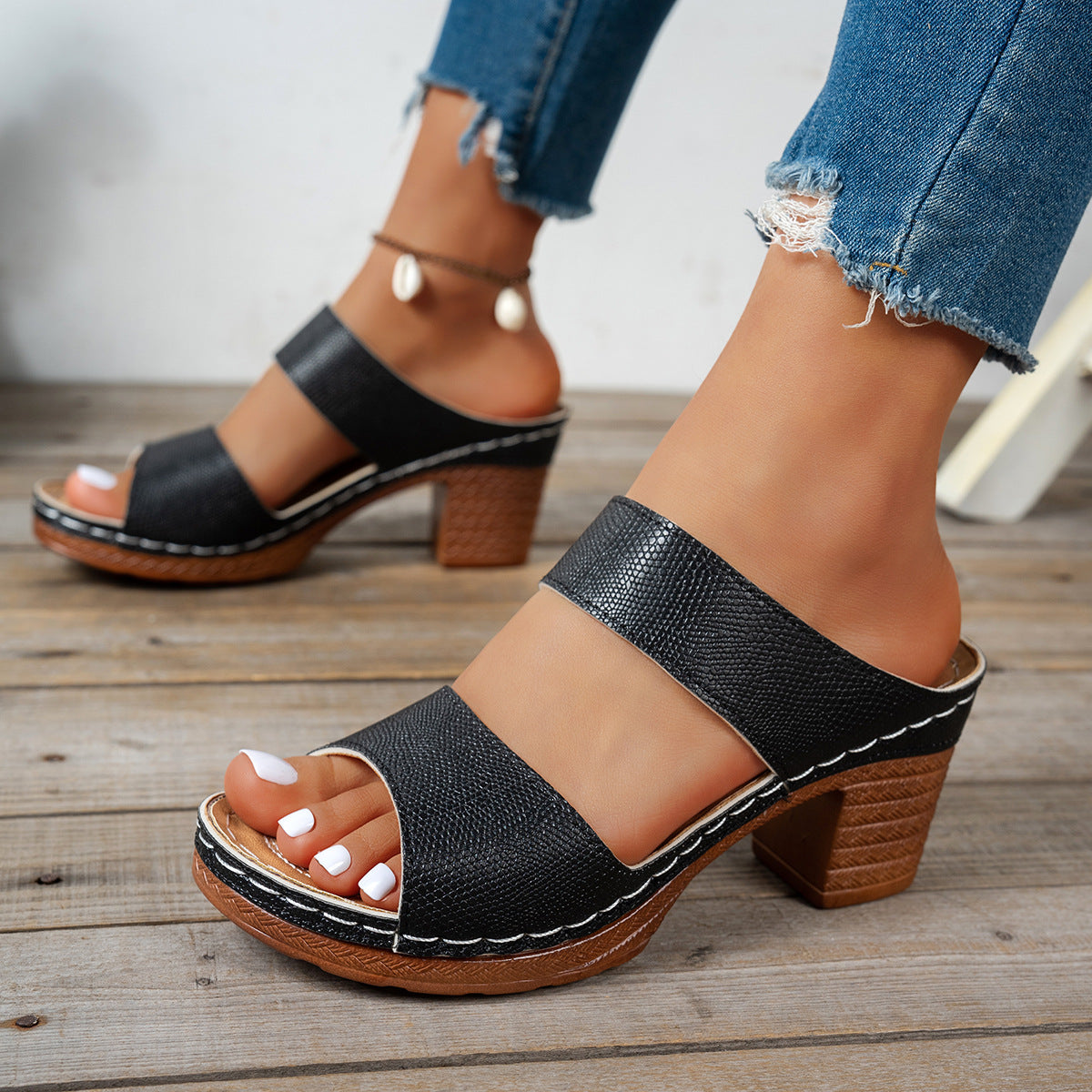 Black textured strap block heel sandals with white stitching detail.