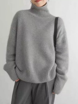 Gray acrylic turtleneck sweater with dropped shoulders and ribbed cuffs and hem.