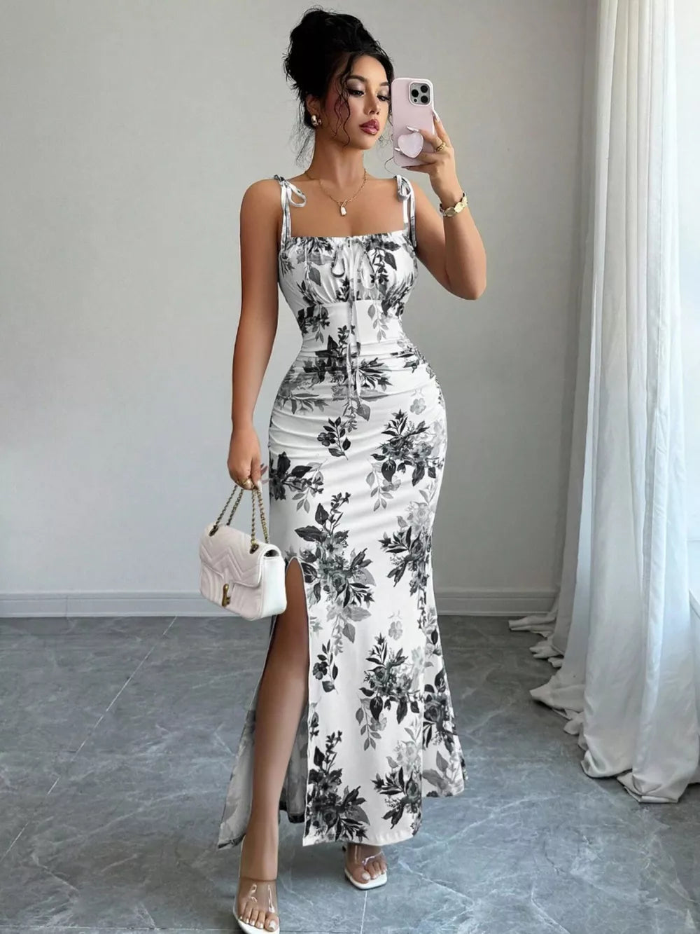 Maxi dress with floral print, tie straps, ruched bodice, and high slit.