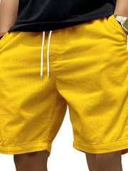 Gold corduroy drawstring shorts with a relaxed fit and white drawstrings.