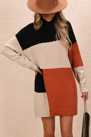 Geometric colorblock knit mini dress with black, camel, and rust panels, featuring a mock neck and long sleeves.