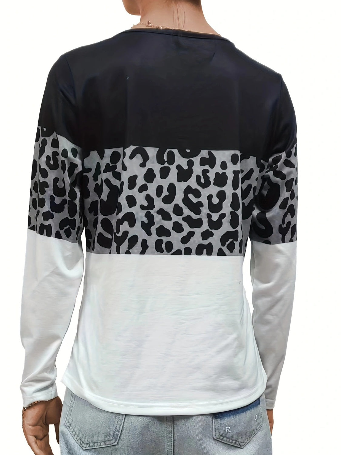 Long sleeve blocked top with leopard print and white sleeves.